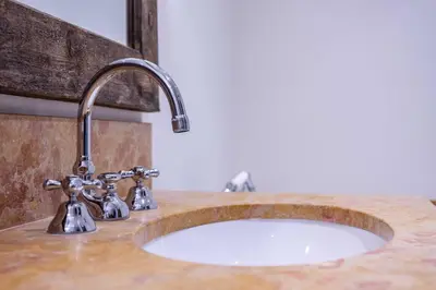 a bathroom sink with a stone counter top with a sink at Spacious Apartment 4BR 10P Megève Center in Megève