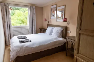 a bedroom with a bed and a window at Spacious Apartment 4BR 10P Megève Center in Megève
