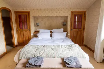 a bedroom with a large white bed with towels on it at Spacious Apartment 4BR 10P Megève Center in Megève