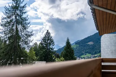 a view of a mountain from a balcony with trees at Spacious Apartment 4BR 10P Megève Center in Megève