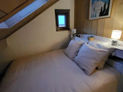 a bed with white pillows in a room at Duplex Centre Station 5 Pers, Animaux Adm - FR-1-836-37 in Arâches-la-Frasse