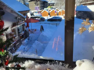 a view of a yard covered in snow from a window at Duplex Centre Station 5 Pers, Animaux Adm - FR-1-836-37 in Arâches-la-Frasse
