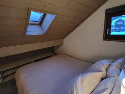 a small bedroom with a bed and a window at Duplex Centre Station 5 Pers, Animaux Adm - FR-1-836-37 in Arâches-la-Frasse