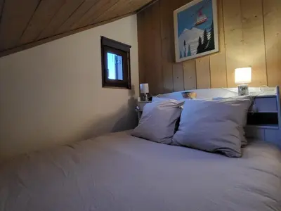 a bedroom with a bed with white sheets and a window at Duplex Centre Station 5 Pers, Animaux Adm - FR-1-836-37 in Arâches-la-Frasse