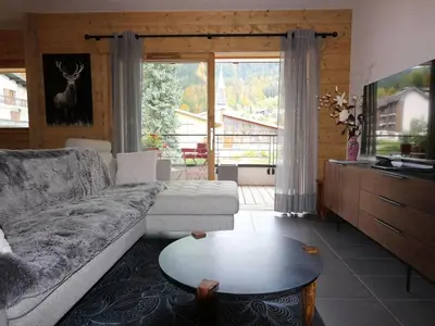 a living room with a couch and a table at Appartement standing 2 chambres, centre Arâches, 5 pers, parking, wifi - FR-1-836-8 in Arâches-la-Frasse