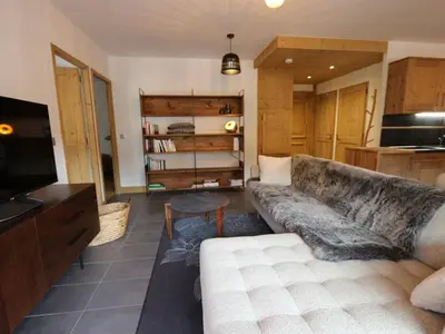 a living room with a couch and a television at Appartement standing 2 chambres, centre Arâches, 5 pers, parking, wifi - FR-1-836-8 in Arâches-la-Frasse