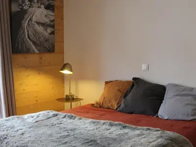 a bedroom with a bed and a lamp next to it at Appartement standing 2 chambres, centre Arâches, 5 pers, parking, wifi - FR-1-836-8 in Arâches-la-Frasse