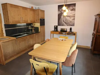 a kitchen with a wooden table and chairs at Appartement standing 2 chambres, centre Arâches, 5 pers, parking, wifi - FR-1-836-8 in Arâches-la-Frasse