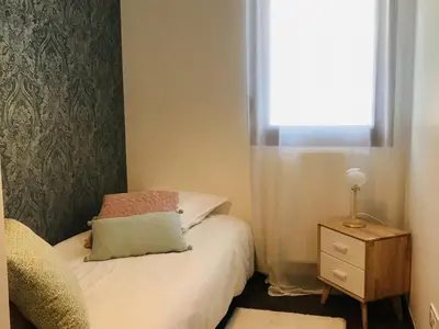 a small bedroom with a bed and a window at Appartement neuf 3 chambres avec jardin et parking à Arâches-la-Frasse - FR-1-836-48 in Arâches-la-Frasse