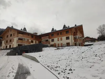 a building with snow on the ground in front of it at Appartement neuf 3 chambres avec jardin et parking à Arâches-la-Frasse - FR-1-836-48 in Arâches-la-Frasse