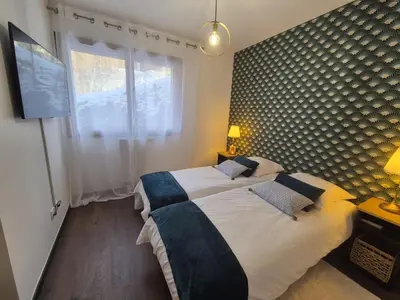 a bedroom with a large bed and a window at Appartement neuf 3 chambres avec jardin et parking à Arâches-la-Frasse - FR-1-836-48 in Arâches-la-Frasse