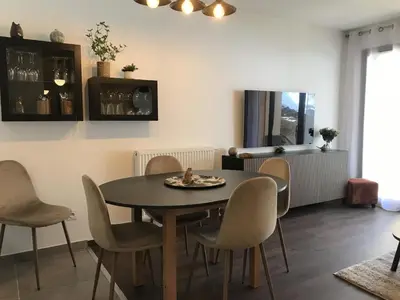 a dining room with a table and chairs at Appartement neuf 3 chambres avec jardin et parking à Arâches-la-Frasse - FR-1-836-48 in Arâches-la-Frasse