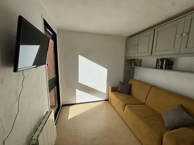 a living room with a couch and a tv at Studio 4 pers, cuisine équipée, parking privé, non-fumeur - FR-1-836-43 in Arâches-la-Frasse