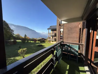 a balcony with a view of a house at Studio 4 pers, cuisine équipée, parking privé, non-fumeur - FR-1-836-43 in Arâches-la-Frasse
