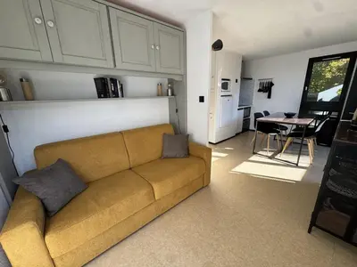 a living room with a couch and a table at Studio 4 pers, cuisine équipée, parking privé, non-fumeur - FR-1-836-43 in Arâches-la-Frasse