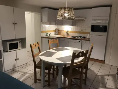 a kitchen with a table and chairs in it at Appartement Chalet 2 Chambres - 6 Pers, Wifi, Parking - FR-1-836-27 in Arâches-la-Frasse