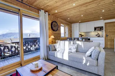 a bedroom with a large bed with towels on it at Arbois Elégance - Ski aux pieds in Megève