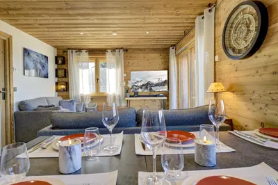 a kitchen and dining room with a table at Arbois Elégance - Ski aux pieds in Megève