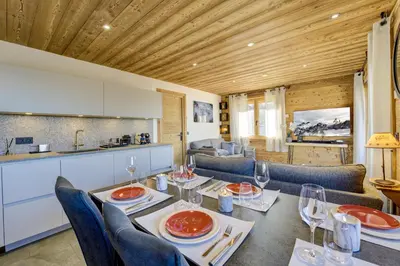 a dining room with a table with wine glasses at Arbois Elégance - Ski aux pieds in Megève