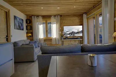 a dining room with a table with wine glasses on it at Arbois Elégance - Ski aux pieds in Megève