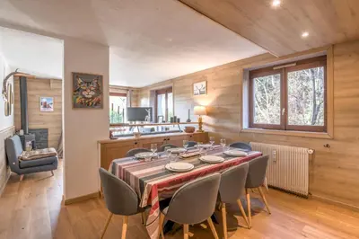a dining room with a table and chairs at Appartement Perret - Welkeys in Megève