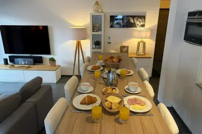 a living room with a couch and two tables at Stay in a modern apartment in Chamonix in Chamonix-Mont-Blanc