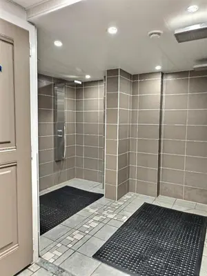 a bathroom with a shower with a glass door at Au cœur de Chamonix – La Ginabelle, Calme avec Piscine, Sauna & Garage in Chamonix-Mont-Blanc