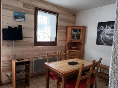 a dining room with a table and a window at Studio cosy avec terrasse, 4 pers, parking privatif - FR-1-836-35 in Arâches-la-Frasse