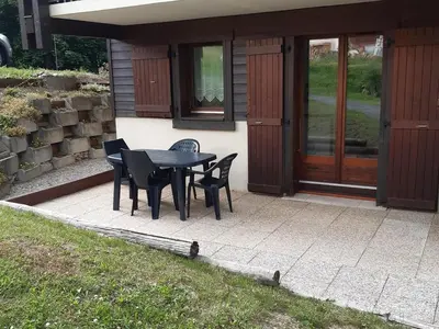 a black table and chairs on a patio at Studio cosy avec terrasse, 4 pers, parking privatif - FR-1-836-35 in Arâches-la-Frasse