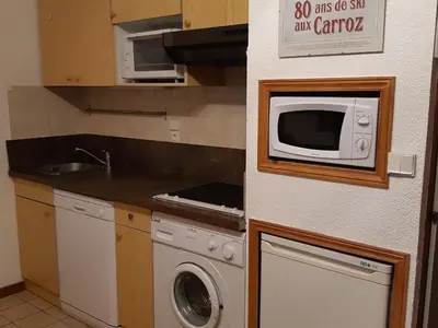 a kitchen with a washing machine and a microwave at Studio cosy avec terrasse, 4 pers, parking privatif - FR-1-836-35 in Arâches-la-Frasse