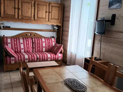 a living room with a red couch and a table at Studio cosy avec terrasse, 4 pers, parking privatif - FR-1-836-35 in Arâches-la-Frasse