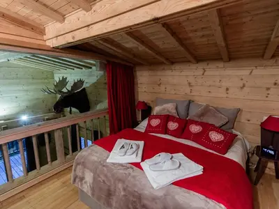 a snow covered balcony with a view of a mountain at Chalet cosy avec jacuzzi, billard, wifi et animaux admis pour 8 personnes - FR-1-836-32 in Arâches-la-Frasse