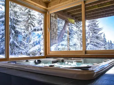 a view of a snow covered mountain from a balcony at Chalet cosy avec jacuzzi, billard, wifi et animaux admis pour 8 personnes - FR-1-836-32 in Arâches-la-Frasse
