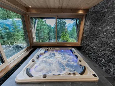 a hot tub in a room with a window at Chalet cosy avec jacuzzi, billard, wifi et animaux admis pour 8 personnes - FR-1-836-32 in Arâches-la-Frasse