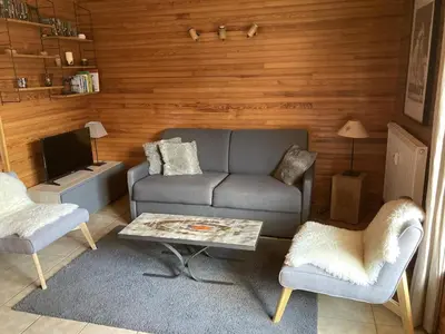 a living room with a couch and a table at Appartement central 2 chambres, 6 personnes, Les Carroz d'Arâches - FR-1-836-25 in Arâches-la-Frasse