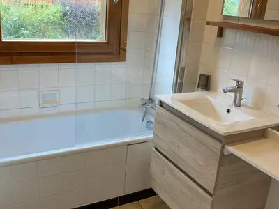 a bathroom with a sink and a bath tub at Appartement central 2 chambres, 6 personnes, Les Carroz d'Arâches - FR-1-836-25 in Arâches-la-Frasse