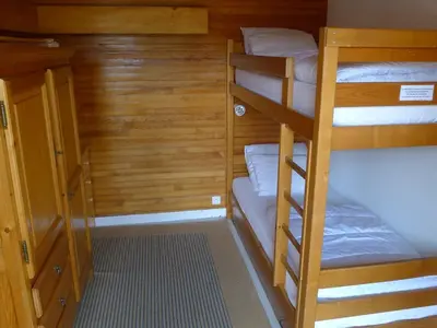 a small room with two bunk beds and a hallway at Appartement central 2 chambres, 6 personnes, Les Carroz d'Arâches - FR-1-836-25 in Arâches-la-Frasse