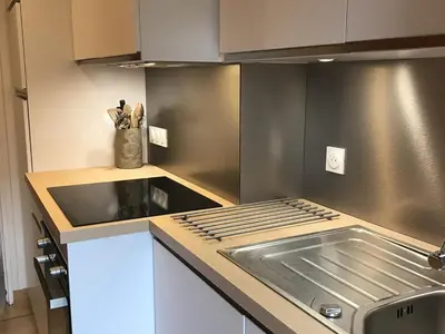 a kitchen with a sink and a counter top at Appartement central 2 chambres, 6 personnes, Les Carroz d'Arâches - FR-1-836-25 in Arâches-la-Frasse