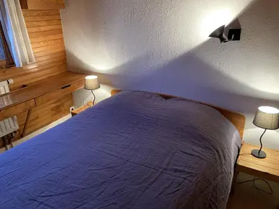a bedroom with a bed and two lamps on two tables at Appartement central 2 chambres, 6 personnes, Les Carroz d'Arâches - FR-1-836-25 in Arâches-la-Frasse