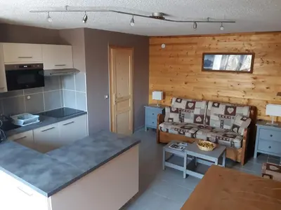 a kitchen and living room with a table and a couch at Appartement rénové - 1 chambre, 6 personnes, animaux acceptés - FR-1-836-34 in Arâches-la-Frasse