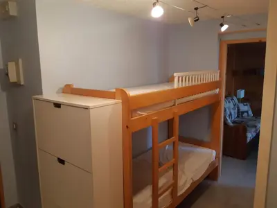 a bunk bed in a room with a desk and a shelf at Appartement rénové - 1 chambre, 6 personnes, animaux acceptés - FR-1-836-34 in Arâches-la-Frasse