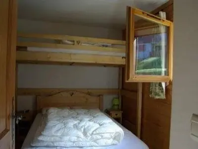 a bedroom with a bunk bed and a window at Appartement 3 pièces, 7 pers, Animaux admis, Parking - FR-1-836-45 in Arâches-la-Frasse
