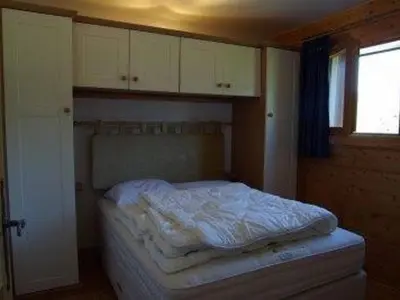 a bed in a room with white cabinets and a window at Appartement 3 pièces, 7 pers, Animaux admis, Parking - FR-1-836-45 in Arâches-la-Frasse