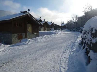 a snow covered street with a row of houses at Appartement 3 pièces, 7 pers, Animaux admis, Parking - FR-1-836-45 in Arâches-la-Frasse
