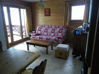 a living room with a couch and a table at Appartement 3 pièces, 7 pers, Animaux admis, Parking - FR-1-836-45 in Arâches-la-Frasse