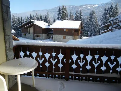 a balcony with a table and a snow covered roof at Appartement 3 pièces, 7 pers, Animaux admis, Parking - FR-1-836-45 in Arâches-la-Frasse