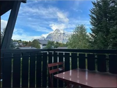 a table on a balcony with a view of a mountain at Duplex 4 chambres, centre à 4min, skibus à la porte, WiFi - FR-1-836-53 in Arâches-la-Frasse