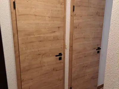 a pair of wooden doors in a room at Appartement 2 pièces au pied de la télécabine avec animaux admis et parking - FR-1-836-30 in Arâches-la-Frasse