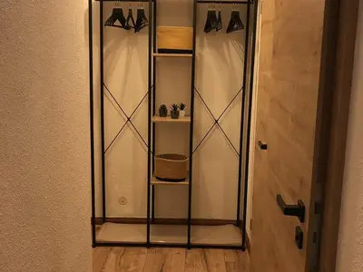 a glass display cabinet with hangers on a wall at Appartement 2 pièces au pied de la télécabine avec animaux admis et parking - FR-1-836-30 in Arâches-la-Frasse