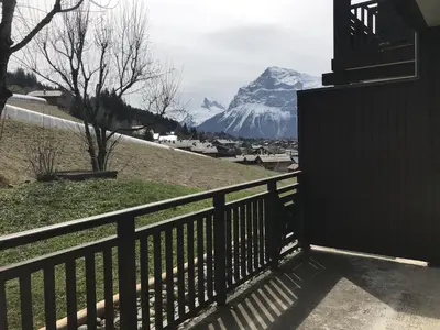 a balcony with a view of a snow covered mountain at Appartement 2 pièces au pied de la télécabine avec animaux admis et parking - FR-1-836-30 in Arâches-la-Frasse